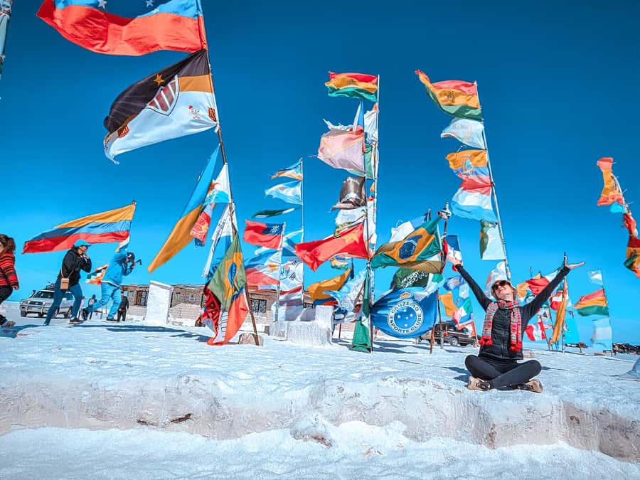 From La Paz: Uyuni Salt Flat Tour & Overnight Roundtrip Bus - Salt hotels, flags, and Ojos de Agua Salada
